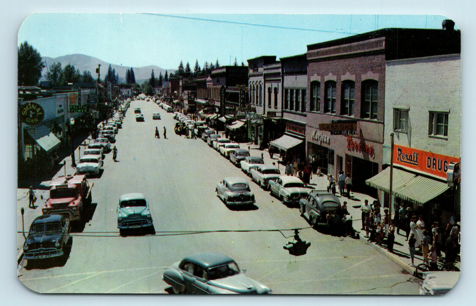Sandpoint, Id   Street Scene Old Cars Signs Storefronts   Postcard